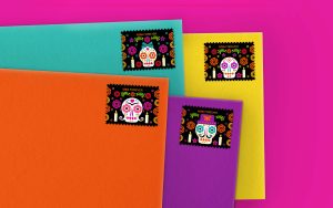 USPS stamps celebrating the Day of the dead on festively colored envelopes.